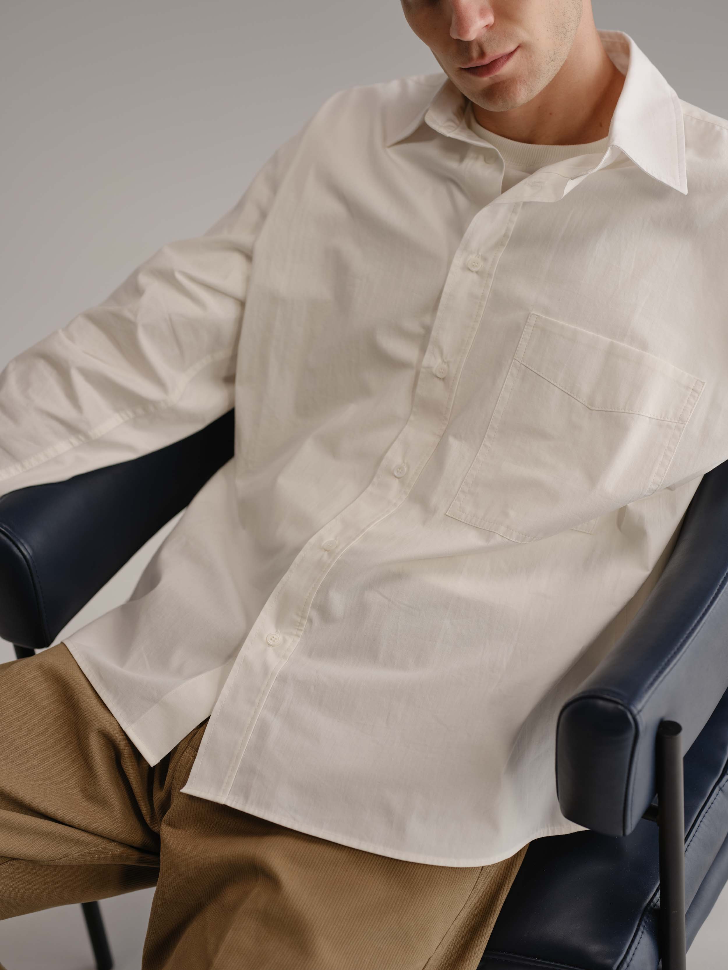 Close up view of white shirt while worn on the body.